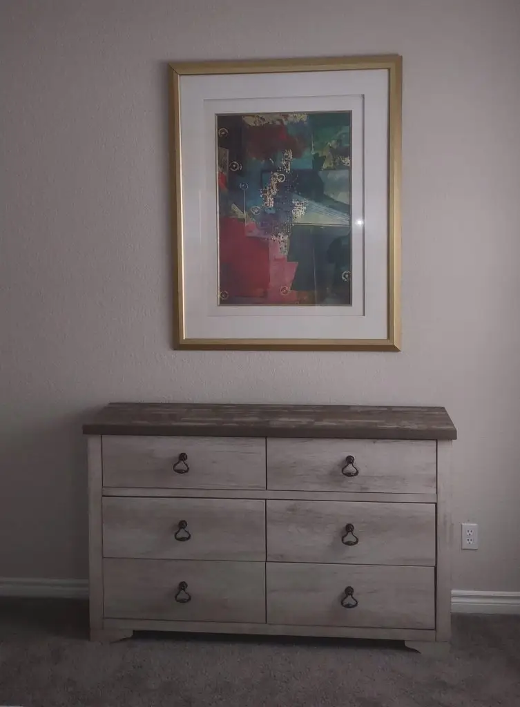 Picture hung above a chest of drawers from furniture assembly project