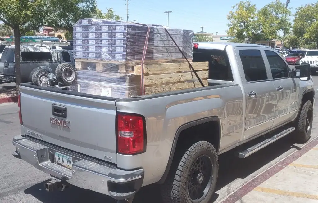 Pick up truck hired for moving help loaded with 2 pallets of flooring