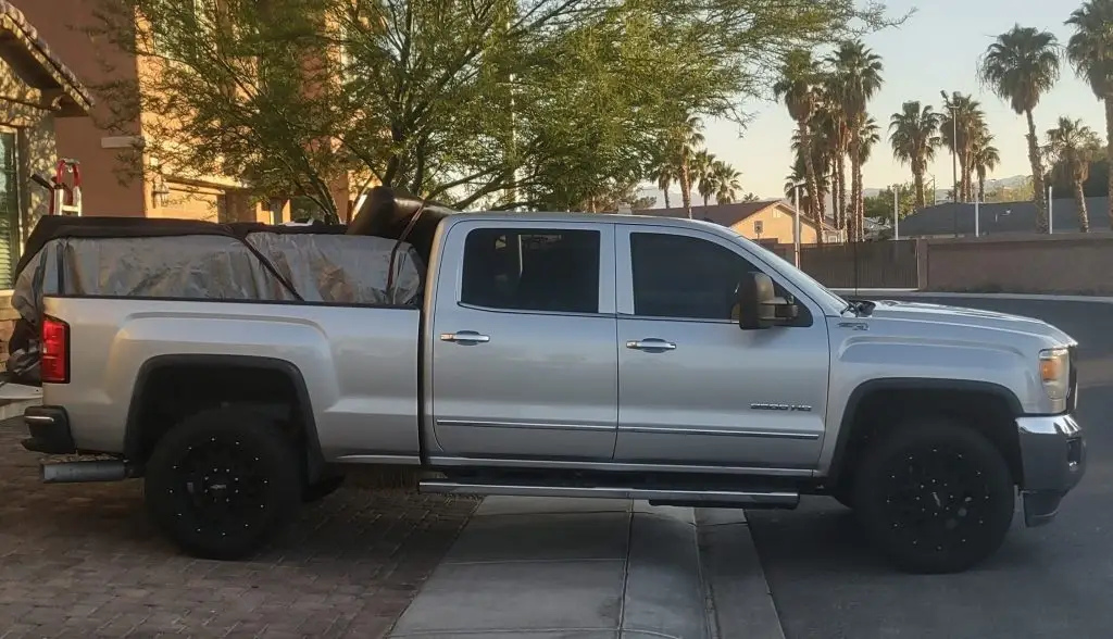 Pick up truck parked in a driveway providing moving help services with furniture