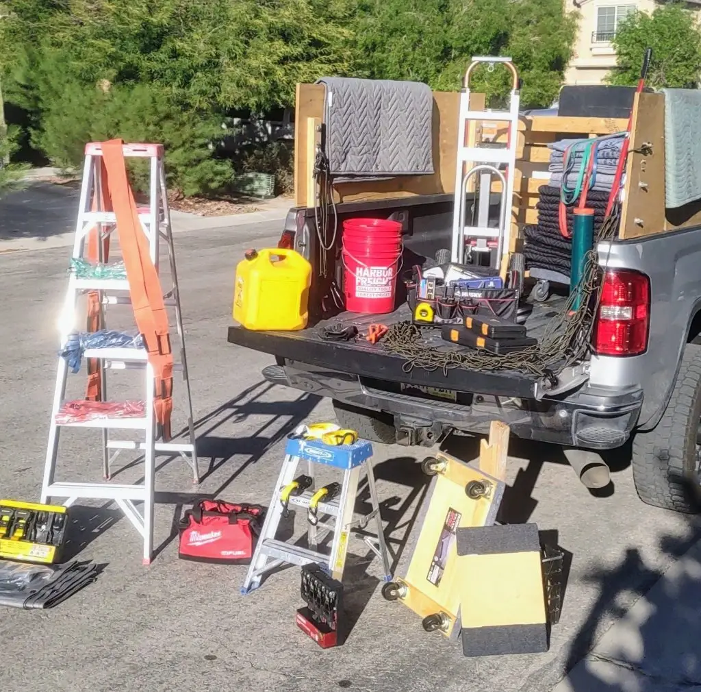 Professional-grade tools and equipment in and around a pickup truck for moving helper services