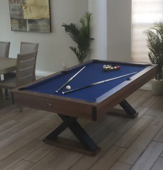 Furniture assembly to a pool table with blue felt, 2 cue sticks and a rack of pool balls